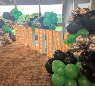 Koltiv Sign and Balloons